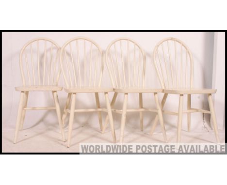 A set of 4 painted white country pine stick back kitchen chairs in the manner of Habitat. Raised on turned legs with stretche