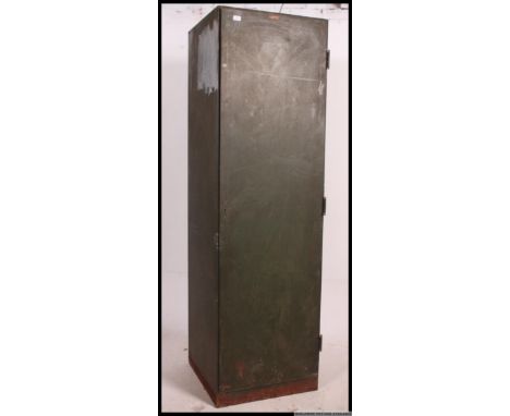 A vintage large industrial possibly military sectional locker / cupboard in green, having a full length door on brass hinges 