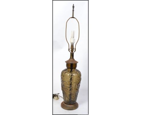 A mid century pressed glass table lamp heavily decorated with ornithology, brass base and original cord