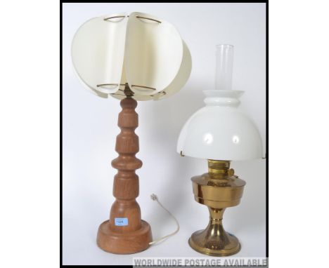 A retro oak mid century table lamp together with a brass and milk glass oil lamp. 23 inch.