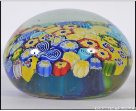 A large glass  20th Century paperweight with a central millefiori cane work panel in mixed colours W10cm