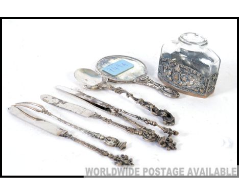 A collection of continental silver and white metal items to include a Dutch silver christening napkin ring, hand mirror, ink 