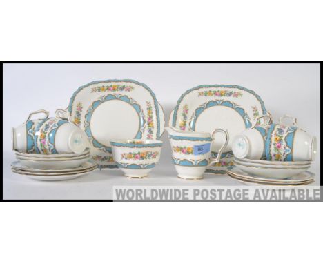 A 20th century vintage Bone China Staffordshire tea service in a chintzy pattern, consisting of six trio's, two sandwich plat