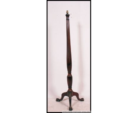 A 19th century Regency mahogany standard lamp on splayed leg tripod base with carved and tapered column Measure: 155 H
