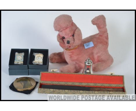 A mixed lot to include a vintage stuffed toy dog with inbuilt radio to underside, two clocks, a vintage Chinese fan, an Elkin