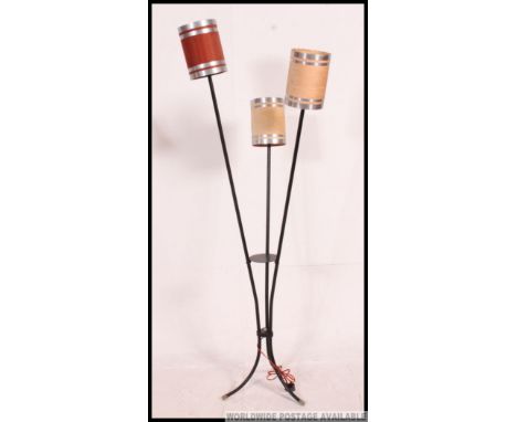 A 20th century French retro floor standing three point lamp, constructed from tubular metal raised on splayed legs