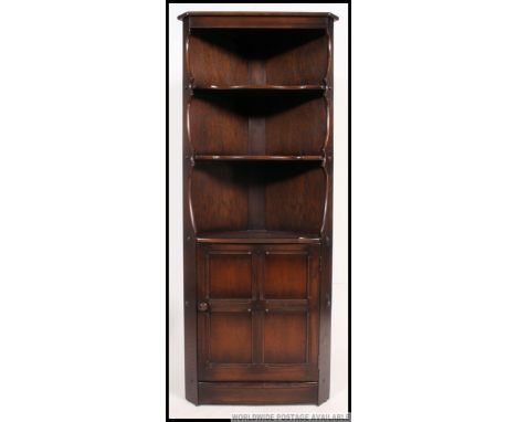 A large Ercol colonial corner cabinet having open shelving over cabinet to the base. Measures: 184 x 71 x 47.