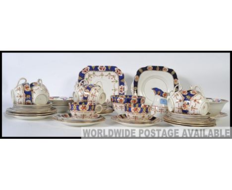 A vintage early 20th century bone china tea service in an Imari pattern by Stanley to include tea cups, saucers, side plates,