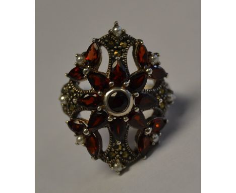 A stunning silver metal, marquisette and ruby garnet stone ring