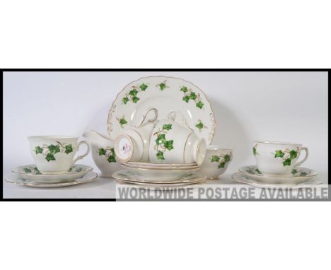 A Colclough part tea service in the Ivy pattern consisting of cups, saucers, side plates, sandwich plates creamer and a sugar