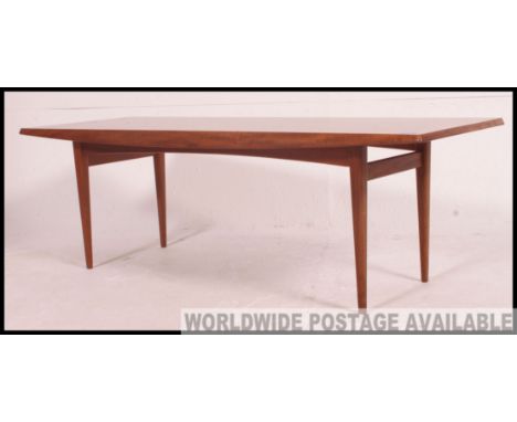 A rare high quality teak coffee table.  Vintage mid century by Gordon Russell ( Label to underside). Measures: 40 x 125 x 45.