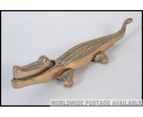 An early 20th century  large cast brass nut cracker in the form of a crocodile L35cm