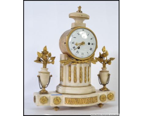 A 19th century Alabaster French mantel cylinder clock flanked by urns with gilded metal floral sprays. The dial marked for Ar
