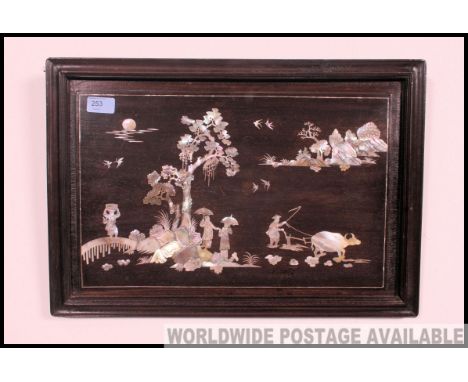 A mid century Chinese mother of pearl inlaid hardwood panel painting. The decorative scene with people and foliates to centre