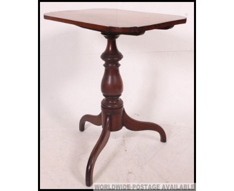 A 19th century Georgian mahogany tilt top tripod wine  table. The base on splayed legs with turned column and shaped square t