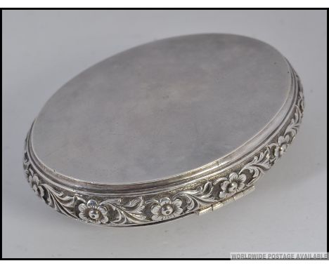 An eastern silver snuff box having squeeze side opening. Chased with flowers etc of lozenge form. Total weight 44.8g