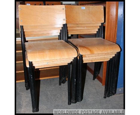 A set of 10 vintage mid century stacking chairs having panel wood seat and back rests being raised on ebonised tubular metal 