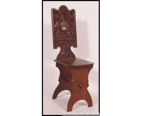 A 19th cenutry carved oak Austrian hall chair. The lyre shaped base with panel seat having stunning twin griffin headed emble