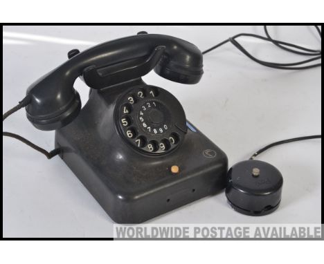 A vintage mid 20th century German bakelite telephone, having a rotary dial