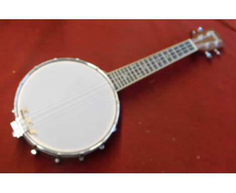 Banjo / Ukelele. 4 String. Wooden body. Made by Irin. Looks unused. Very good condition.