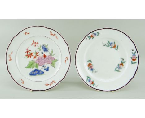 TWO NANTGARW PORCELAIN PLATES WITH CHOCOLATE RIMS enamel painted flowers, impressed NANT GARW CW to both, 24cms diam and 23cm