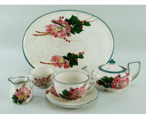 A LLANELLY POTTERY FIVE-PIECE CABARET SET comprising oval tray, teapot, cream-jug, sugar basin and teacup and saucer, typical