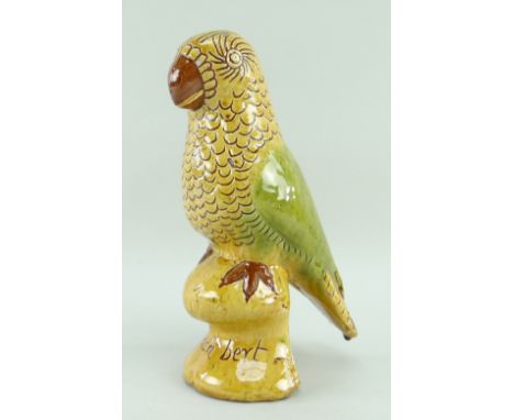 EWENNY POTTERY MODEL OF A PERCHED PARROT in red slip with sgraffito and yellow, brown and green over glaze, inscribed 'Polly 