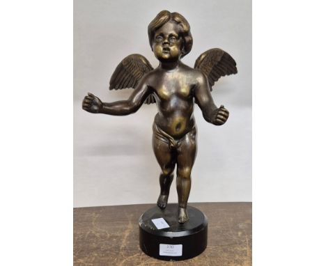 A bronze figure of a cherub on metal socle 