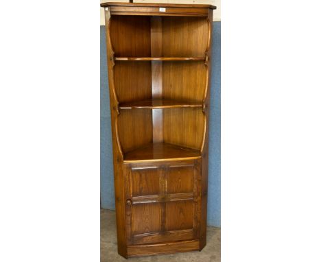 An Ercol Golden Dawn elm freestanding corner cabinet 