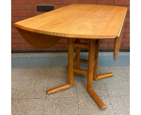 An Ercol Blonde elm drop leaf dining table 