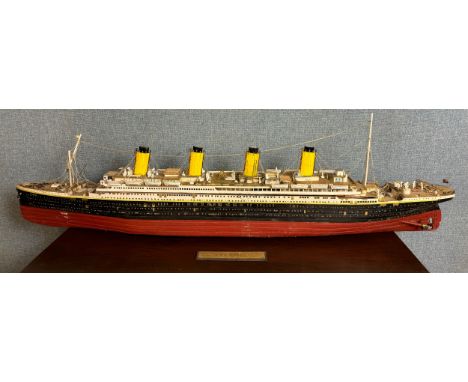 A remote control model Titanic, 110cms l, with Titanic related magazines and plans 