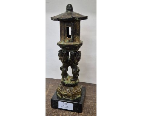 An Oriental bronze incense burner, on a black marble socle 