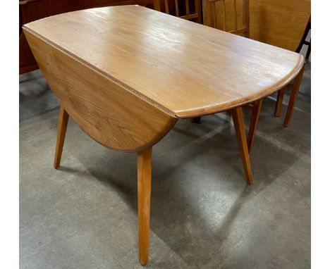 An Ercol Blonde elm and beech Windsor drop leaf table 