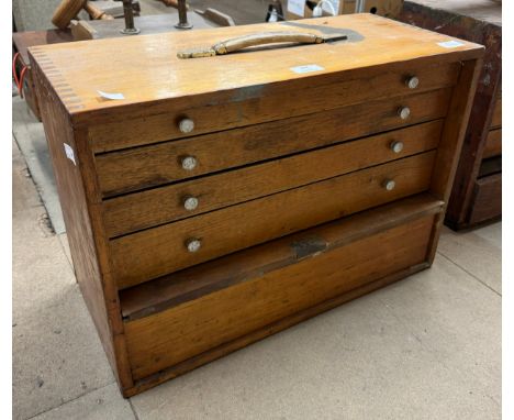 A pine engineers tool box containing tools 