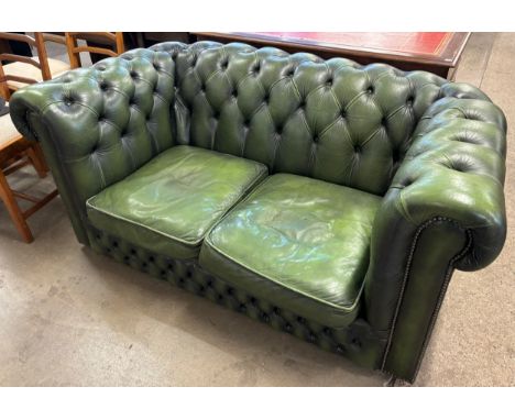 A green leather upholstered Chesterfield sofa 