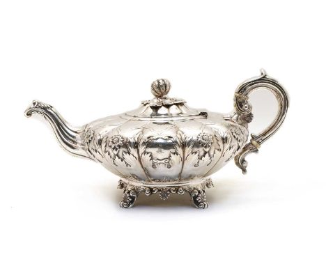 A William IV Irish silver teapot, by James Fray, Dublin 1836, of lobed form, with floral decoration, ivory insulators and mel