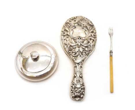 A Victorian silver dressing mirror, wtih embossed decoration, London 1889, together with a silver topped glass powder jar and