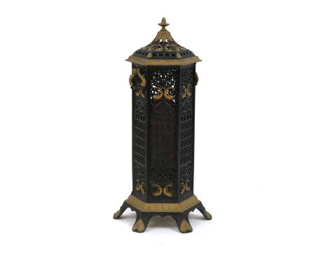 A Gothic Revival wrought iron and gilt veritas stove, of hexagonal form, with a domed top, with latticed sides, each with a r