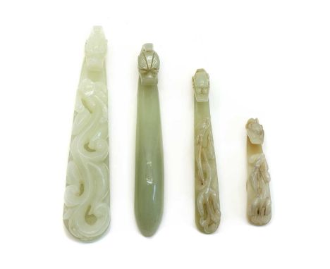 A collection of Chinese jade belt hooks, of typical form, comprising: three with a dragon's head to one end and a chilong cli