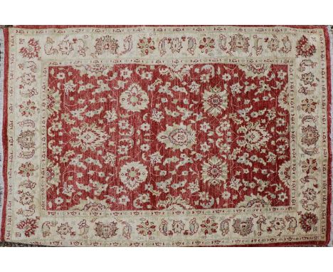 A near pair of Pakistani wool rugs of Persian Ziegler design, of recent manufacture, each decorated with Shah Abbasi motifs o