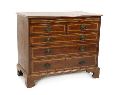 A George III style mahogany and crossbanded chest of drawers, with a brushing slide over two and three, graduated long drawer