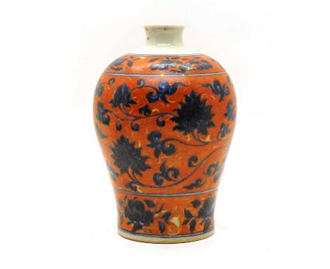 A Chinese meiping vase, of baluster form, with scrolling lotus in blue against an iron red ground, a six-character Xuande mar