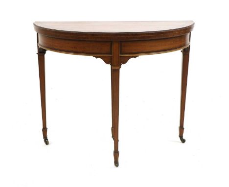 An Edwardian satinwood demi lune card table, the foldover top on tapering square tapering supports, 91cm wide, 46cm deep, 74c