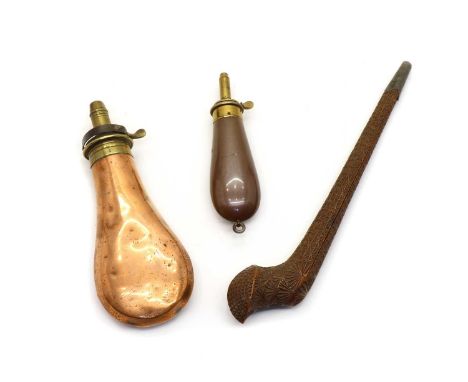 Two copper and brass powder flasks and a wooden pipe case, the first stamped 'Colt's pocket flask' and 'James Dixon &amp; Son