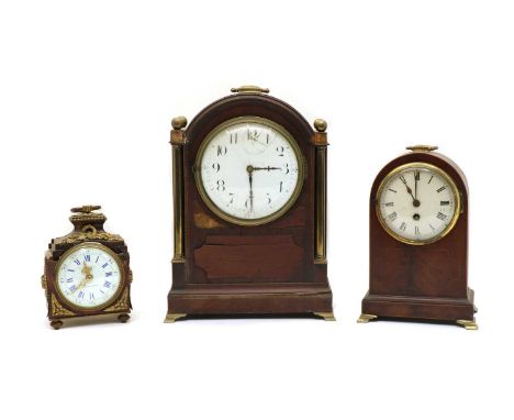 A mahogany mantel clock, of arched form, 37cm high, together with a similar smaller example, 27.5cm high and another example 