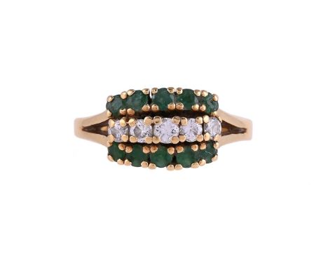 
	
		A MID 20TH CENTURY DIAMOND AND EMERALD DRESS RING
		The central row of brilliant cut diamonds, between two rows of circu