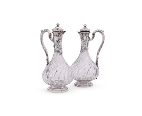 
	
		A PAIR OF FRENCH SILVER MOUNTED CUT GLASS CLARET JUGS
		BOIN-TABURET, CIRCA 1900
		With spiral domed finials to the dome