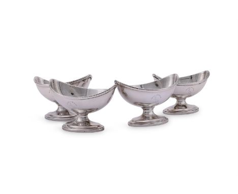 A SET OF FOUR GEORGE III SILVER NAVETTE SALTS HENRY NUTTING, LONDON 1799 Engraved with a crest and on oval pedestal feet 10cm