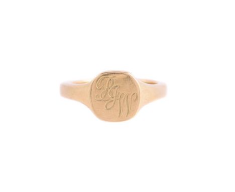 
	
		AN 18 CARAT GOLD SIGNET RING 
		LONDON 1986
		The cushion shaped panel engraved with the initials MIE, to tapered should