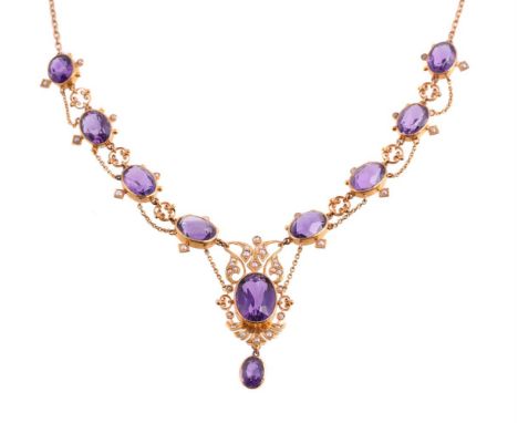 
	
		AN EDWARDIAN AMETHYST AND SEED PEARL NECKLACE 
		CIRCA 1910
		The central panel with scrolled foliate and shell detail, 